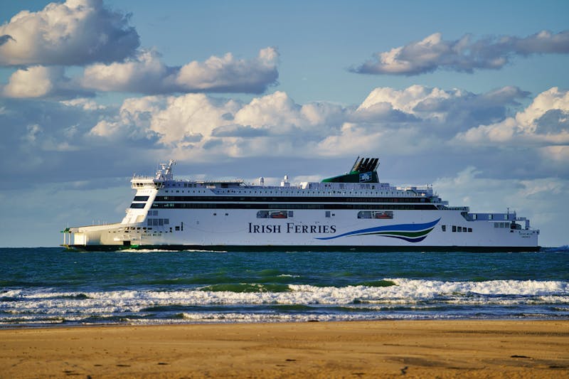 Modern passenger ferry sailing along a coastline